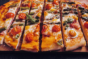 Sliced asparagus and prosciutto pizza with mozzarella closeup