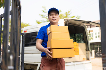 Portrait of cheerful young delivery man with camera Home delivery service and transportation concept