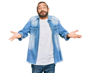Attractive man with long hair and beard wearing casual denim jacket clueless and confused expression with arms and hands raised. doubt concept.