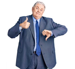 Senior grey-haired man wearing business jacket doing thumbs up and down, disagreement and agreement expression. crazy conflict