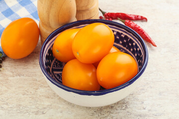 Sweet ripe yellow tomato in the bowl