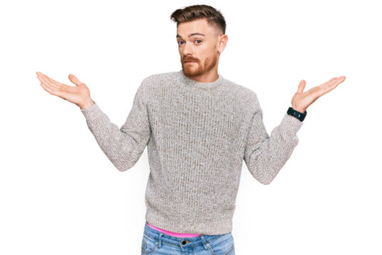 Young redhead man wearing casual winter sweater clueless and confused expression with arms and hands raised. doubt concept.
