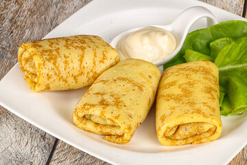 Stuffed pancakes with cream sauce