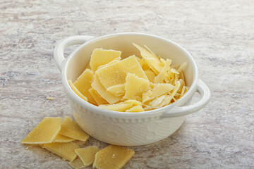 Sliced parmesan cheese heap in the bowl