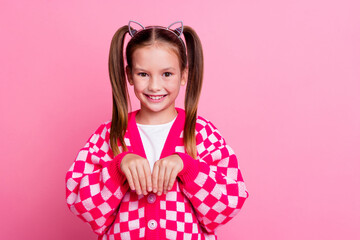 Photo of funky adorable girl with tails hairstyle cat ears dressed cardigan hold hands like paws...