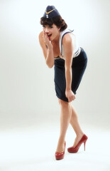 Portrait, surprise and pin up of woman flight attendant in studio on gray background for vintage fashion. Travel, wow and gossip with shocked young air hostess in work uniform for retro service