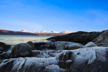 mountain panorama with icy rocks in the foreground