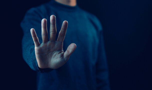 person's hand showing palm gestures stop concepts of violence, warning, refuse, and defense. the hand sign of men a stop, caution 