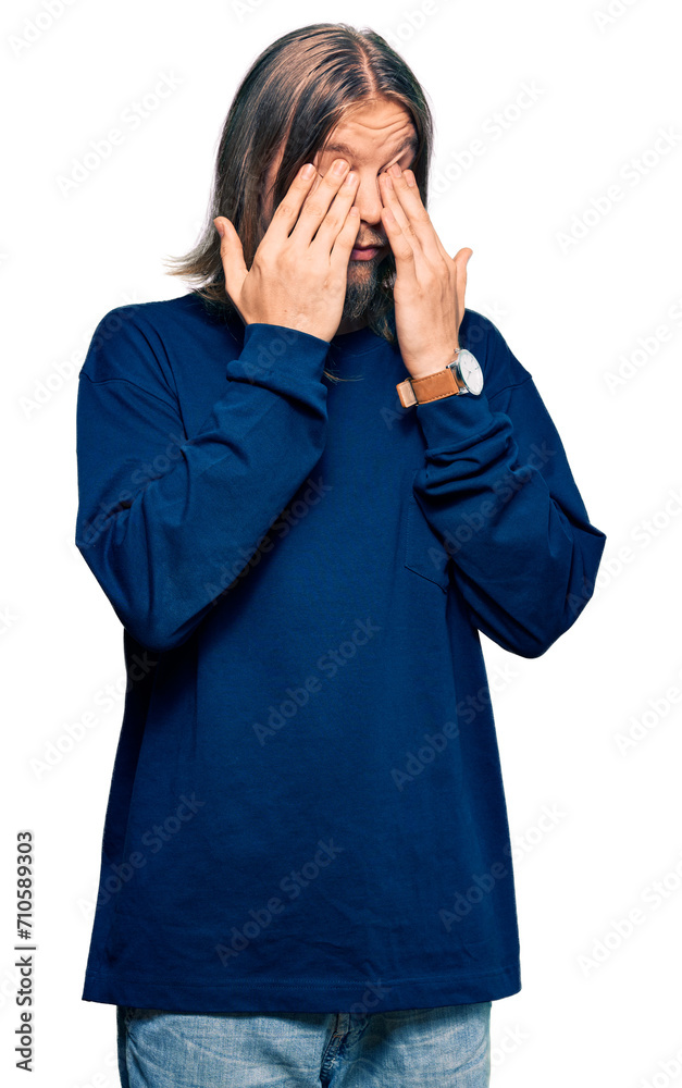 Wall mural Handsome caucasian man with long hair wearing casual winter sweater rubbing eyes for fatigue and headache, sleepy and tired expression. vision problem