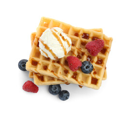 Tasty Belgian waffles with ice cream, berries and caramel syrup on white background, top view