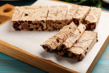 Pieces of tasty chocolate halva on table, closeup