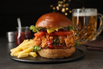 Delicious burger with crispy chicken patty and french fries on black table - Powered by Adobe