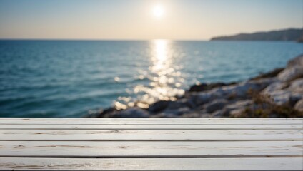 Fototapeta na wymiar A background with an empty white wooden table and the sea or ocean. Sunset, bright sun. Spring or summer wallpaper with an empty space. Natural bokeh. Rays of light. Daylight.
