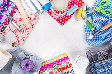 Fototapeta premium DIY upcycling ideas and materials background. Sustainable hobby with handmade, ecology creative reusable hand made with plastic bottles, metal cans, old jeans, fabrics, glass containers, top view