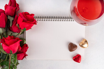 Valentines day  background with red roses, wine, gift box and chocolate candy copy space for your text