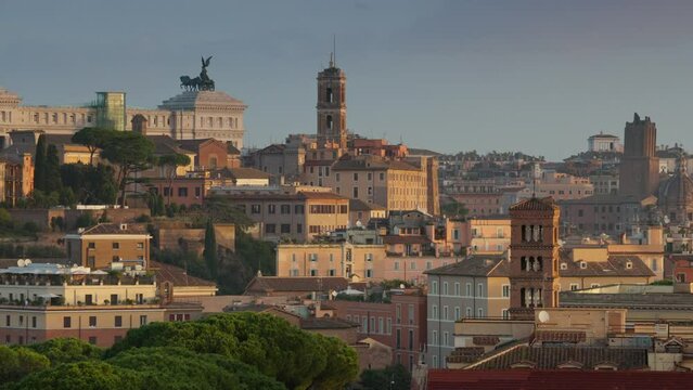 Panning shot of morning Rome, Italy. Sunrise view from Terrazza Belvedere Aventino in Rome. Altare della Patria, old houses and churches