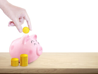Putting coins into a piggy bank with a pile of gold coins on a wooden table PNG transparent