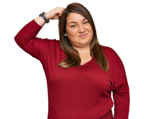Beautiful brunette plus size woman wearing casual clothes confuse and wonder about question. uncertain with doubt, thinking with hand on head. pensive concept.