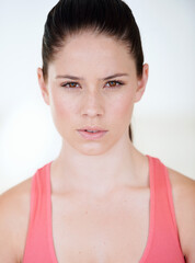 Portrait, fitness and sports with a young woman in studio on a white background for health or wellness. Natural face, exercise and a serious female athlete looking confident with her training