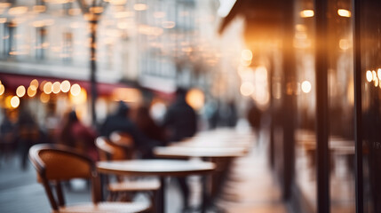 Unfocused cafes and buildings. Blurred out of focus background. View of the city with lights in the evening, beautiful bokeh and blur of the city. Street traffic.