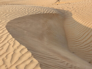 Desert sand texture with line pattern top view Spring sunset gates Sahara desert, with the sand...