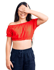 Fototapeta premium Brunette teenager girl wearing casual clothes smiling and laughing with hand on face covering eyes for surprise. blind concept.