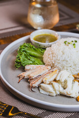 Boiled chicken rice mixed with crab meat on a wooden table