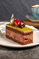 Pistachio cake. Strawberry and pistachio cake on dark background. Close up
