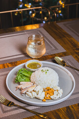 Boiled chicken rice mixed with crab meat on a wooden table