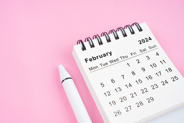 February 2024 month calendar on pink fabric background.