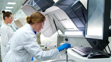 A medical research laboratory with a diverse team of biochemical scientists working with computers and modern medical technologies. Development of high-tech equipment for medicines.