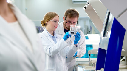 A medical research laboratory with a diverse team of biochemical scientists working with computers and modern medical technologies. Development of high-tech equipment for medicines.