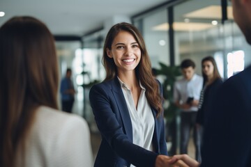 Happy 30 years old business woman manager handshaking at office meeting. Smiling female hiring recruit at job interview.