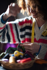 Fototapeta na wymiar Serene Adult Female Caucasian Taylor Sewing By Hand a Cloth in her Workshop
