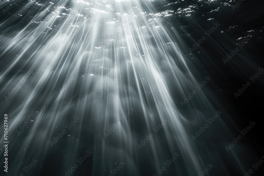 Poster Sunlight shining through the water, creating a captivating black and white photo. Perfect for adding a sense of tranquility and depth to any project