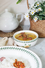 A bowl of creamy butter milk chicken. Selective focus. Overexposed.