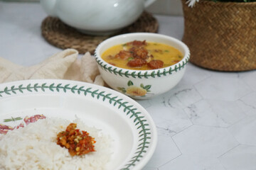A bowl of creamy butter milk chicken. Selective focus. Overexposed.