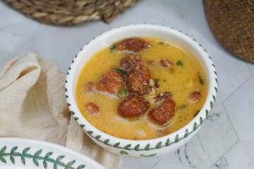 A bowl of creamy butter milk chicken. Selective focus. Overexposed.