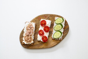 Ingredients for sandwich with boiled egg, cherry tomatoes, canned tuna, garlic and spices on grey white background. High quality photo