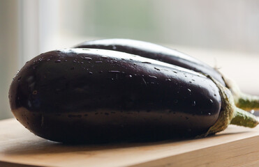 Fresh Elegance: Eggplants on Wooden Board Close-Up