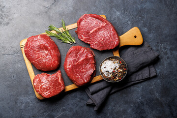 Raw beef fillet steaks on a cutting board, fresh and uncooked