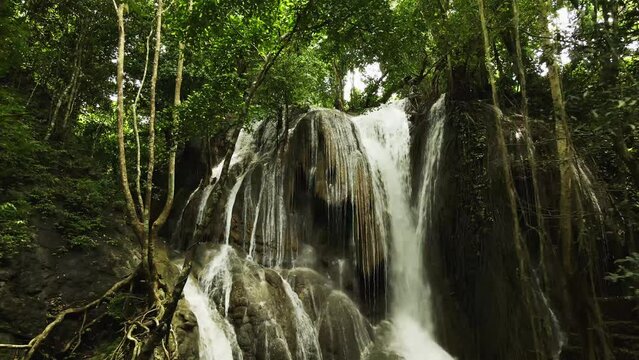 aerial shot in waterfall from Sumbawa island, Indonesia. Drone view. Jungles and waterfall on a sunny day. Royalty-free stock footage