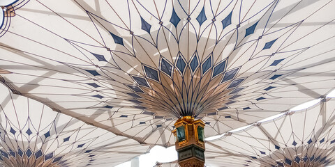MEDINA, SAUDI ARABIA - APRIL 28 2018: These Umbrella construction on the square of Al-Masjid An-Nabawi or Prophet Muhammed 