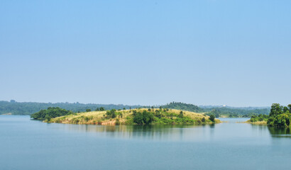 Famous alpine Scenic view of the lake, island and blue sky with clouds, outdoor travel background at Ayodha Hill, Purulia, in West Bengal, India. - obrazy, fototapety, plakaty
