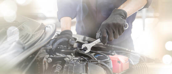 Car care maintenance and servicing, Close-up hand technician auto mechanic using the wrench to...