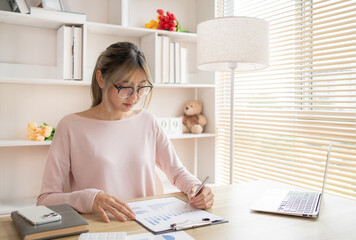 Employees working in the office, Businesswoman analyzes data graphs and works intently in his personal office,  Businessman at Desk.