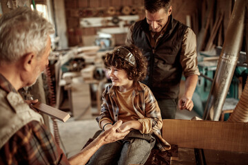 Multi-generational family woodworking together in a workshop