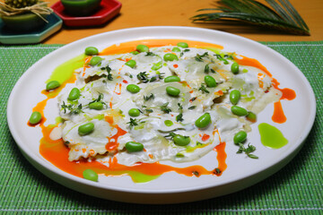 Italian tortellini pasta in cream sauce.with spinach. White wooden background. Top view