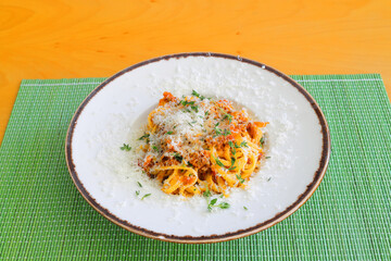 Spaghetti bolognese - Italian traditional dish. Mediterranean cuisine with pasta ingredients - bolognese sauce, olive oil and tomato.