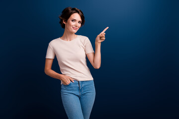 Portrait of pretty lady worker indicate finger side empty space wearing casual trendy clothes...